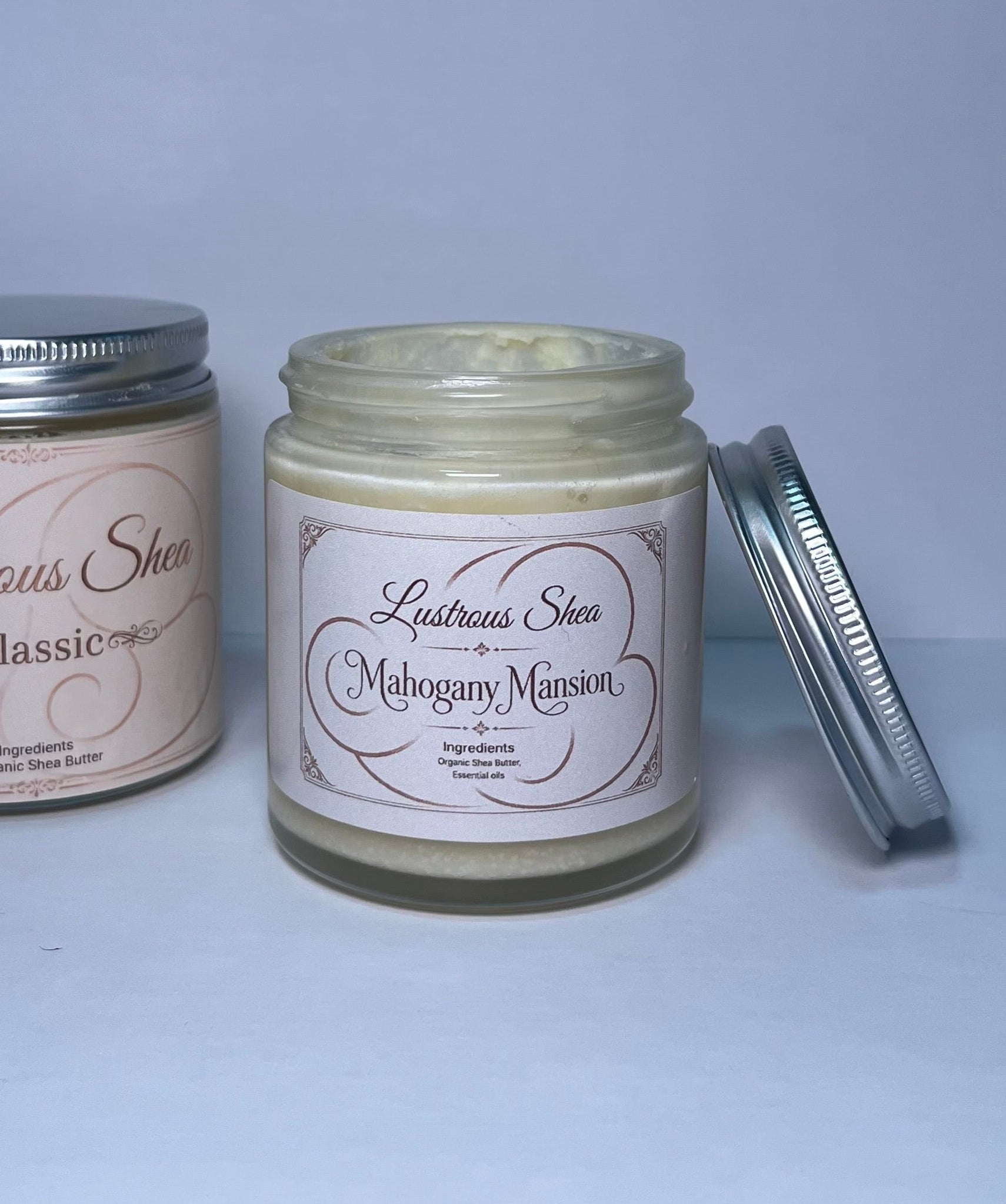 Two jars of Lustrous Sheen on a light gray background